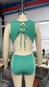 Detail of glitter green swimwear back with criss-cross straps and bowknot design
