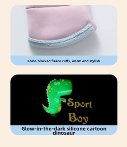 Detail of warm plush fleece cuffs and luminous cartoon dinosaur patch on kids ski gloves