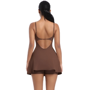 Detail of dark brown backless athletic dress with cross straps and flare skirt