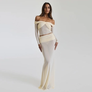 Detail view of beige tube top with long sleeves and high waist maxi skirt in mesh fabric