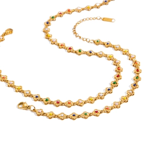 Gold stainless steel necklace with colorful beaded flower links on a white background