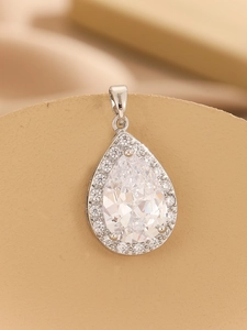 Macro shot of silver teardrop pendant with clear zircon cluster and sleek metal clasp