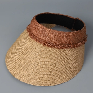 Detail of bohemian woven trim and raffia texture on a women's sun visor hat