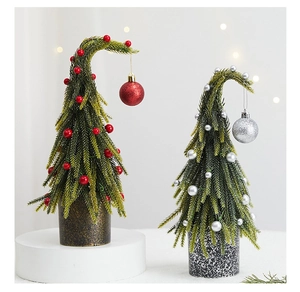 Detailed view of mini Christmas trees with colorful berries and textured round bases