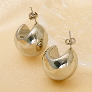 Polished gold-plated C-shape chunky hoop earrings with mirror finish on champagne silk