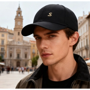 Close-up of black baseball cap with golden Sports embroidery on cotton twill fabric