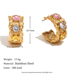Macro detail of gold C-shaped earrings with colorful inset crystals and size dimensions
