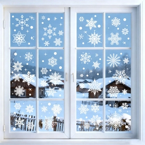 Detailed white snowflake window decals on glass with a winter landscape background