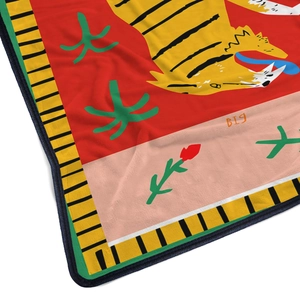 Detailed close-up of red flannel blanket with vintage tiger and cactus floral pattern