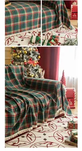 Detail of red and green plaid Christmas blanket featuring delicate cream fringe tassels