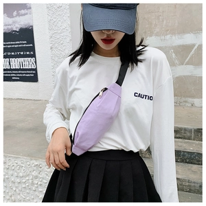 Close-up of a purple canvas waist bag with adjustable black strap and silver zipper detail