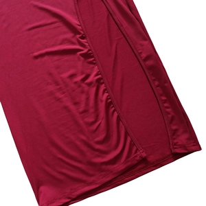 Detail view of the side slit and high-quality stitching on a dark red bodycon dress