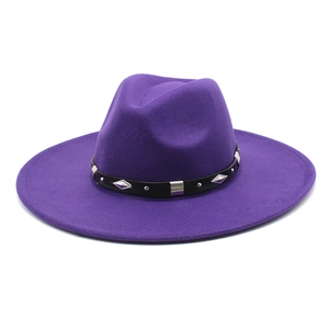 Detail of deep purple fedora hat featuring a studded black leather decorative band