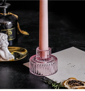 Detail of pink ribbed glass candle holder with elegant vertical relief for dining decor