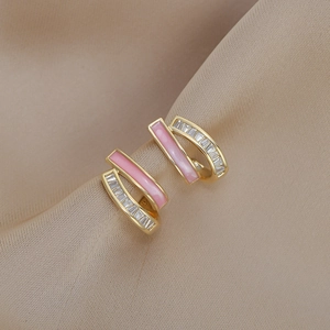 Detail of pink enamel double layer earrings with pave set zircons on silk fabric