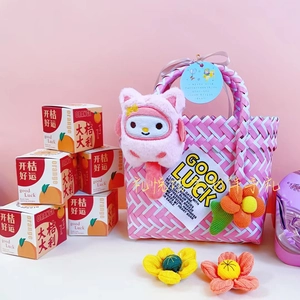 Pink woven gift basket with plush rabbit pendant and festive orange gift boxes