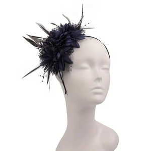 Detailed view of dark blue feather bridal fascinator headpiece with mesh on mannequin head