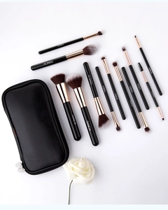 Close-up of 12-piece makeup brush set with rose gold ferrules and a black PU leather zip pouch