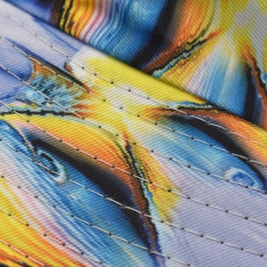 Macro detail of 3D tie-dye printed fabric with precise parallel stitching on bucket hat