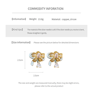 Detail view of bow earrings showing 2.5cm size, 13.8g weight, and zircon material