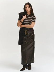 Detail of slim fit striped polo shirt paired with high waist brown leather skirt