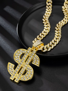 Detailed macro view of gold plated dollar sign pendant with sparkling pavé crystals