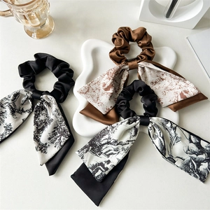 Elegant vintage style satin scrunchies with long ribbons featuring retro floral patterns