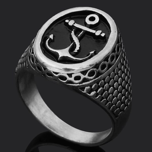 Detailed macro shot of vintage silver anchor signet ring with viking rune textures