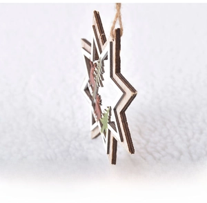 Side view showing layered wooden Christmas star with laser-cut reindeer and tree details