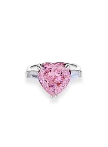Macro shot of heart-cut pink cubic zirconia stone with baguette side gems on silver ring