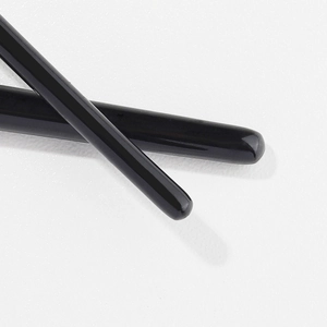 Flat angled eyeliner and eyebrow brush with a minimalist glossy black finish