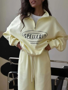 Detail of light yellow half-zip sweatshirt and matching drawstring joggers set