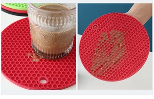 Macro detail of red honeycomb silicone coaster with hanging hole and waterproof droplets