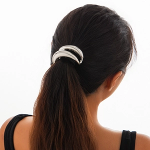 Detail view of a vintage silver double-layer elastic hair ring on a ponytail