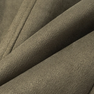 Close-up detail of dark olive green faux suede fabric texture and stitching on jacket