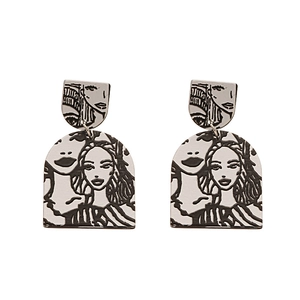 Minimalist silver geometric earrings with artistic black line art woman portrait