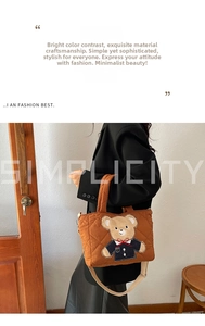 Close-up of caramel quilted tote bag featuring a cute cartoon bear patch and adjustable strap