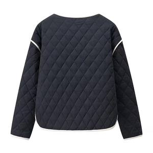 Detail of black diamond-quilted jacket back view with white contrast piping on collar and hem