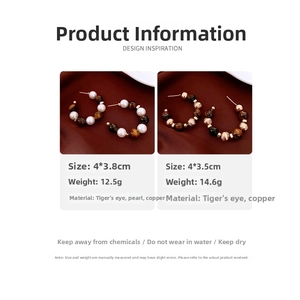 Detail view of tiger eye stone and pearl hoop earrings with size and weight specs