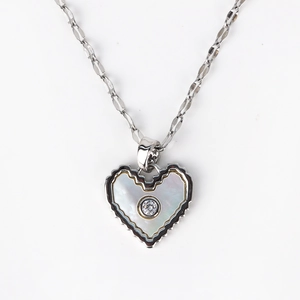 Detail of scalloped heart necklace with white mother of pearl and zircon centerpiece