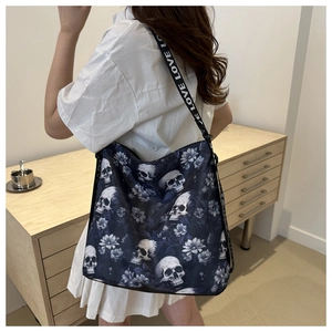 Detail of large navy tote bag with skull floral print and LOVE letter shoulder strap