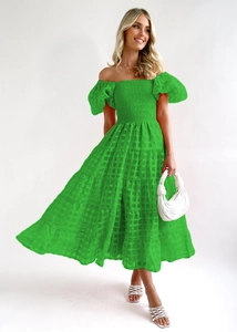 Detail of lime green off-shoulder dress featuring tiered ruffle layers and plaid texture