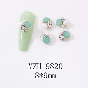 Detail of mint green cat eye stone bow nail charms with pearls and crystal size 8x9mm