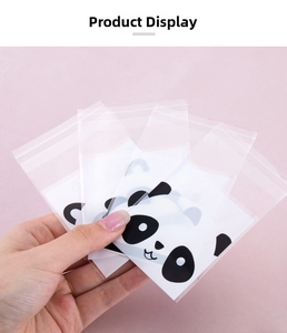 Detail of transparent self-sealing bags with cartoon panda prints for cookie packaging