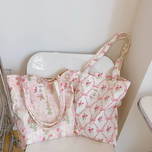 Floral cotton canvas tote bags with pink flower patterns on a white chair