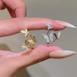 Close-up of gold and silver butterfly rings with pavé cubic zirconia setting