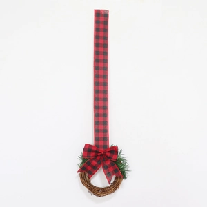 Detail of Christmas wreath with red black plaid bow and natural vine ring on white background