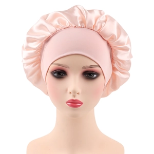 Detail view of the pink satin sleep bonnet with elastic wide band on a mannequin