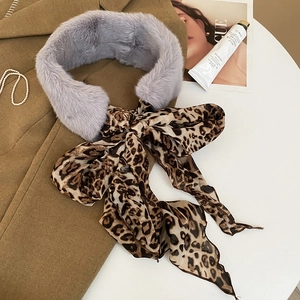 Detail of grey faux fur collar scarf with leopard print ribbon bow on wool coat