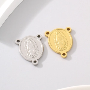 Macro view of gold and silver Virgin Mary connectors with three connection holes